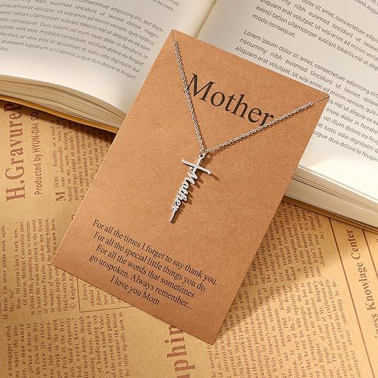 Silver cross pendant necklace with Mother word charm on a delicate chain.