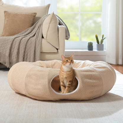 Beige donut cat play tunnel bed with round entrance opening and textured plush cover.