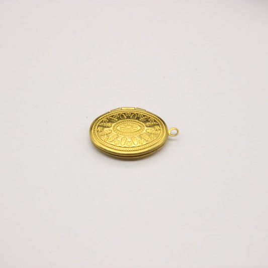 Oval gold-toned engraved clasp charm with a small hanging loop