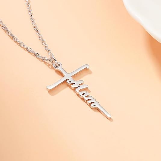Silver cross pendant necklace with Faith word charm on a delicate chain.