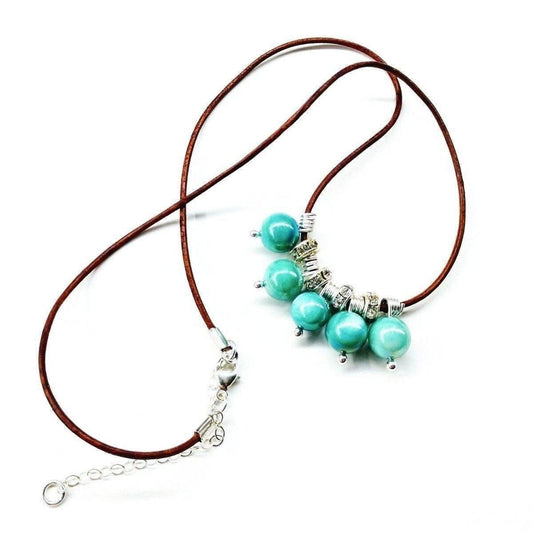 Brown leather cord necklace with turquoise shell bead cluster and silver accents