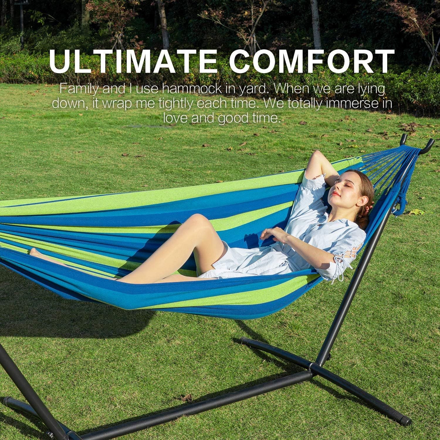 Double hammock with stand, blue striped fabric hammock on black steel frame outdoors