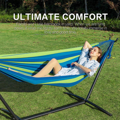 Double hammock with stand, blue striped fabric hammock on black steel frame outdoors