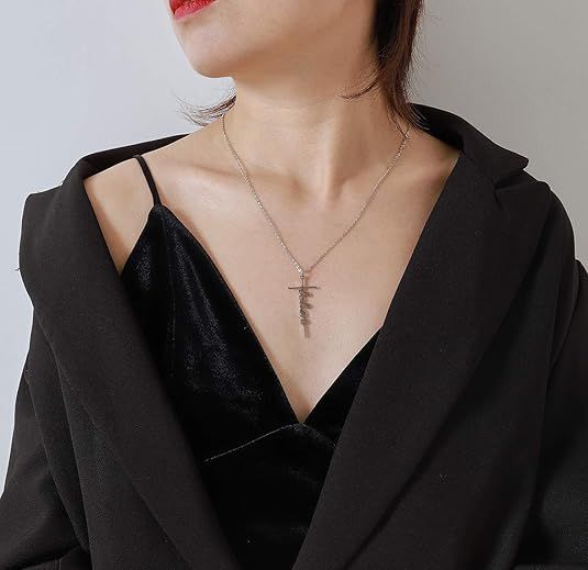 Faith-style cross pendant necklace worn with a black V-neck top