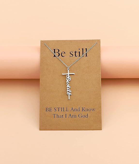 Silver-tone cross with “Be still” cursive pendant on a fine chain necklace