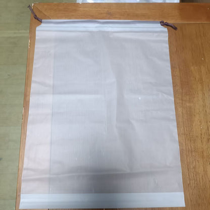 Transparent rectangular storage bag with dark braided drawstring cord along top seam