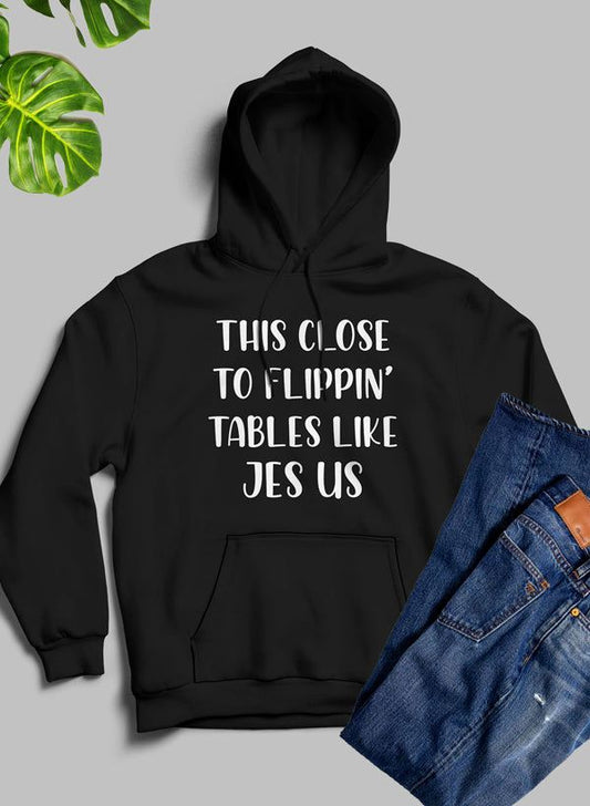 Black hoodie with front graphic text and kangaroo pocket