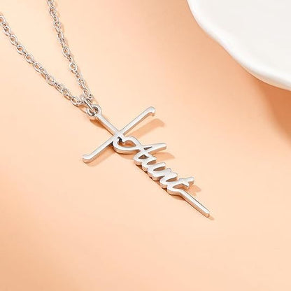 Faith cross pendant necklace with a cursive charm on a silver-tone chain