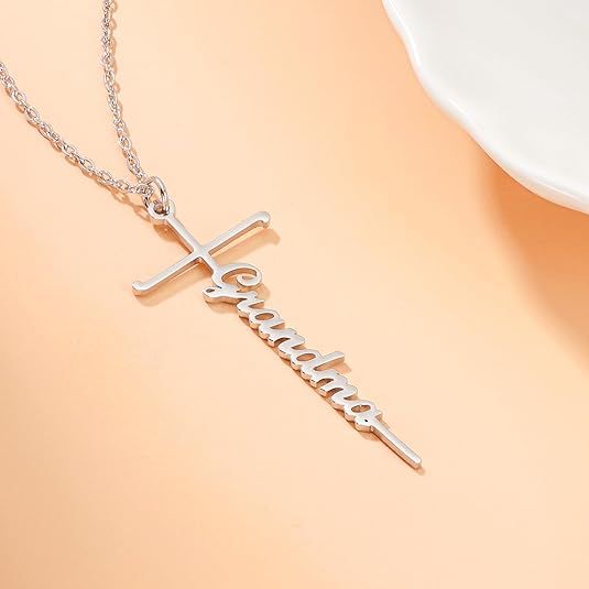 Silver cross pendant necklace with Faith word charm on a delicate chain.