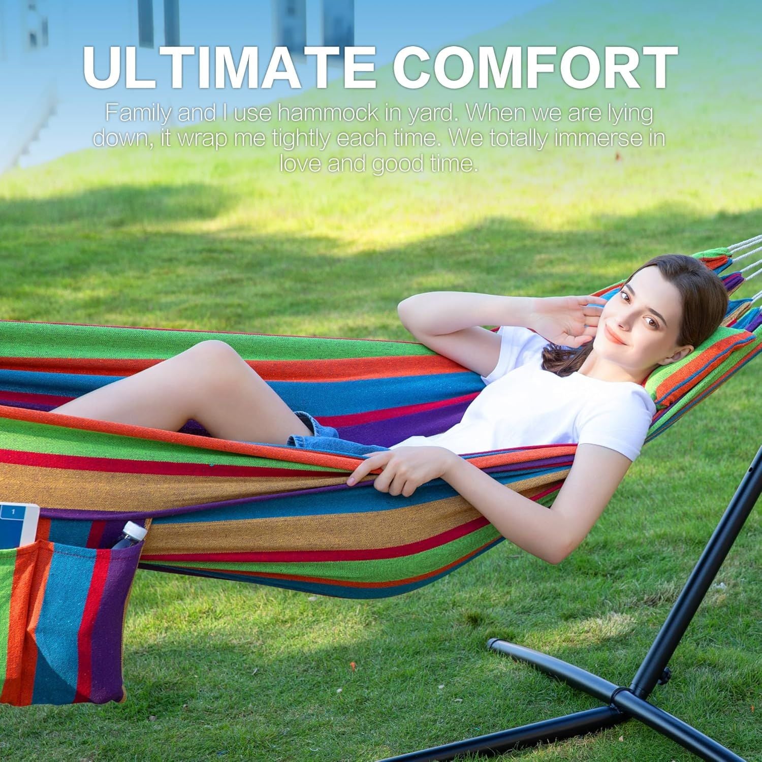 Double hammock with stand, colorful striped hammock with black frame outdoors with person relaxing