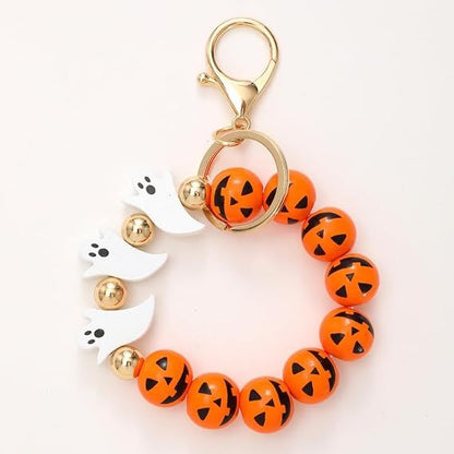 Halloween beaded keychain with orange jack-o-lantern beads and white ghost paw charms