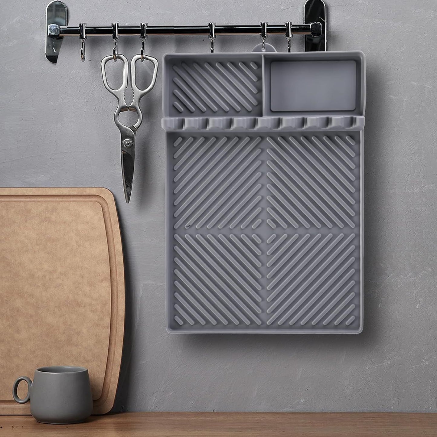 Gray silicone tools mat with ridged drip channels and raised compartments for spatulas.