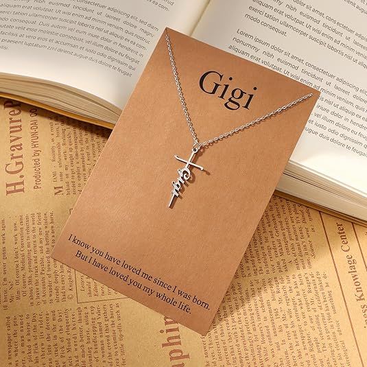 Silver cross pendant necklace with Gigi word charm on a delicate chain.