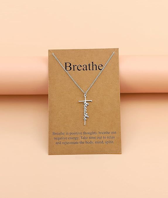 Silver-tone cross with “Breathe” cursive pendant on a fine chain necklace