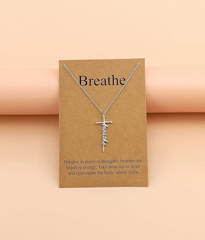 Silver-tone cross with “Breathe” cursive pendant on a fine chain necklace