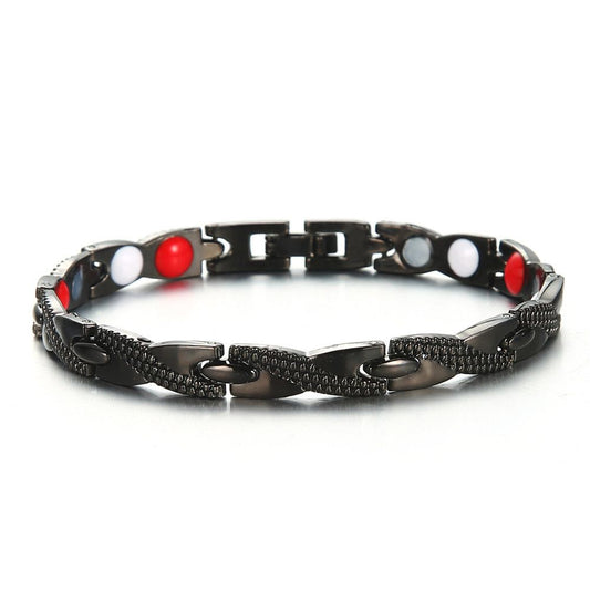 Black and silver link health bracelet with textured panels, red and white round beads