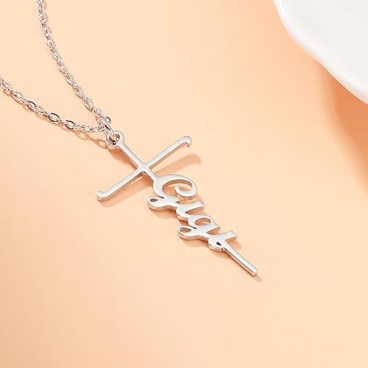 Silver cross pendant necklace with Love word charm on a delicate chain.