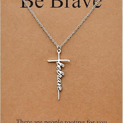 Silver cross pendant necklace with Be Brave script charm on a chain