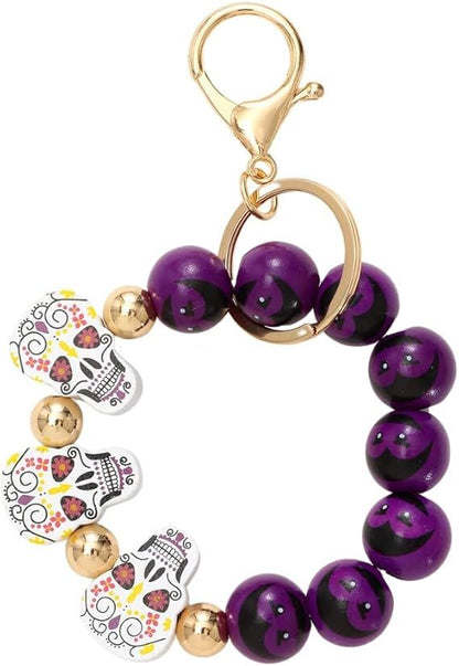 Halloween beaded keychain ring with purple beads and cartoon bat and pumpkin charms