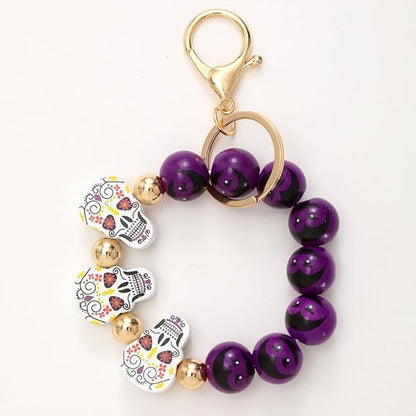 Halloween beaded keychain with purple round beads and white pumpkin ghost charms