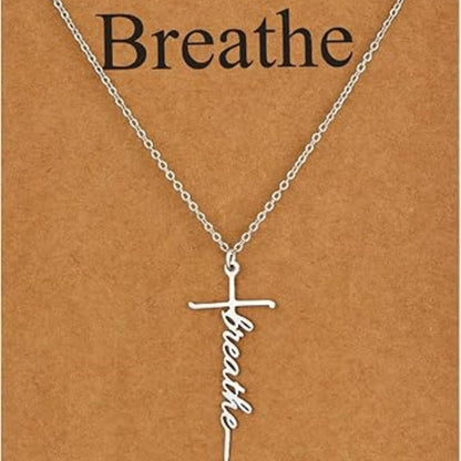Faith cross pendant necklace with “Breathe” script charm on silver chain