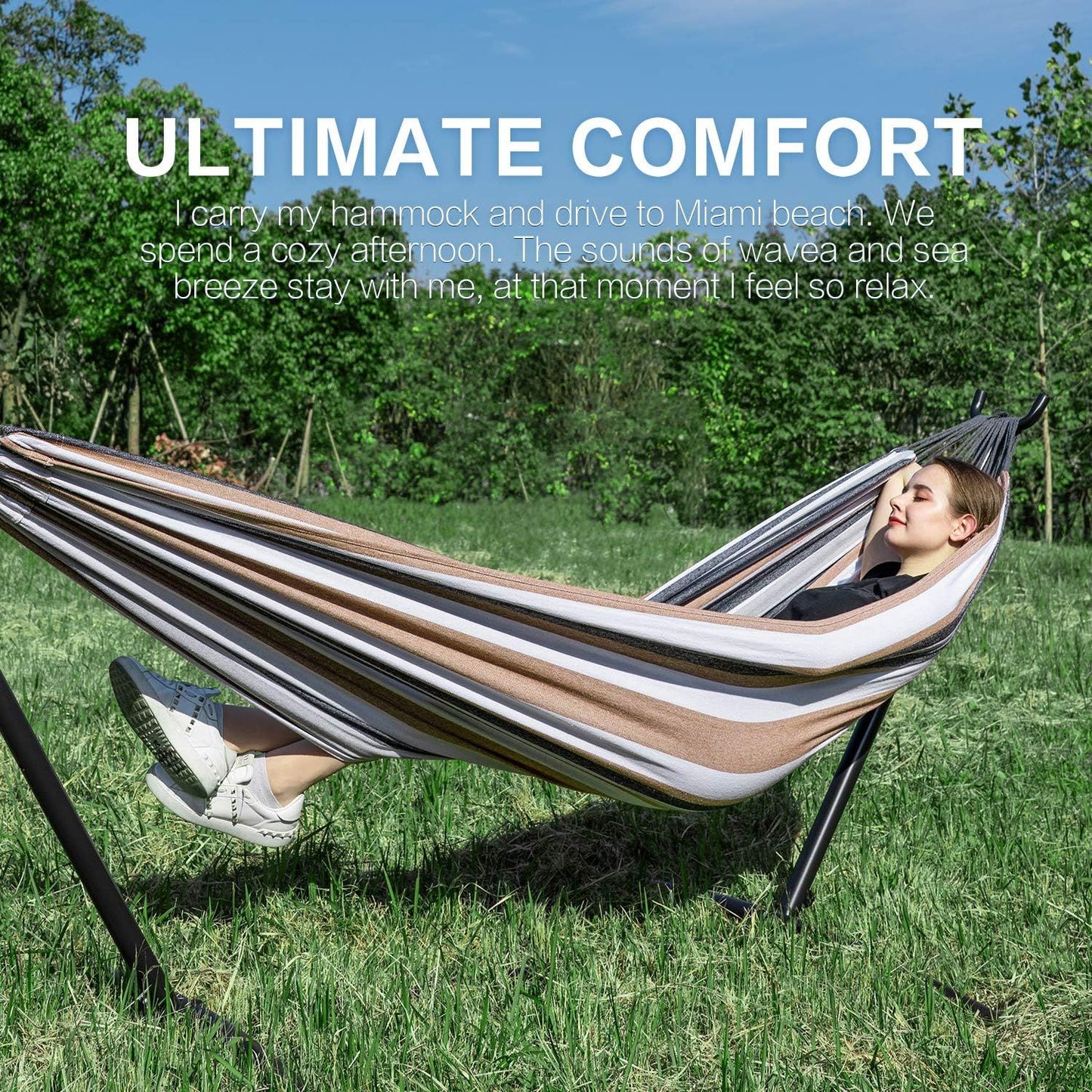 Double hammock with stand, brown and white striped hammock on black steel frame outdoors