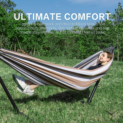 Double hammock with stand, brown and white striped hammock on black steel frame outdoors