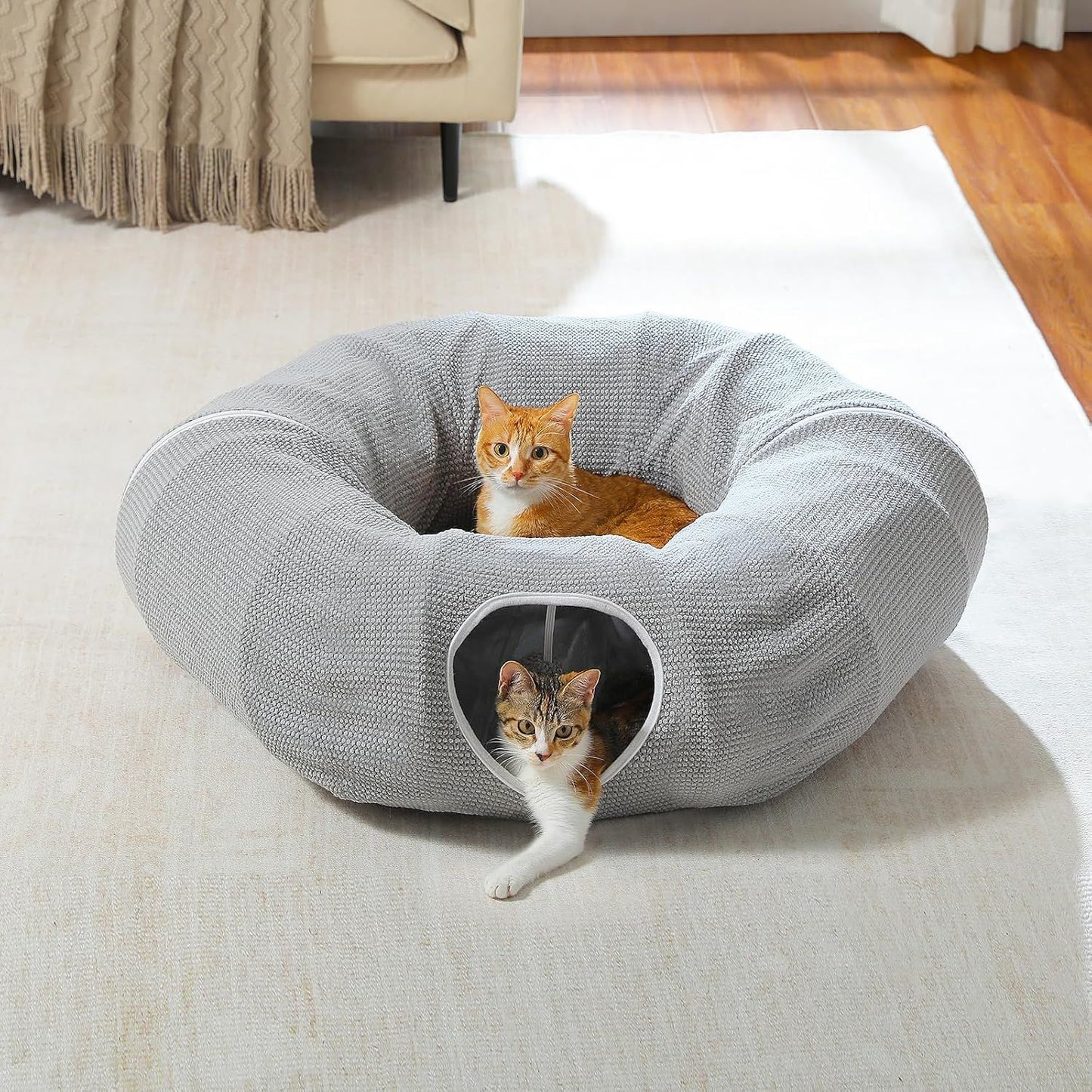 Gray cat donut tunnel bed with plush cushion and side entrance opening, cat inside