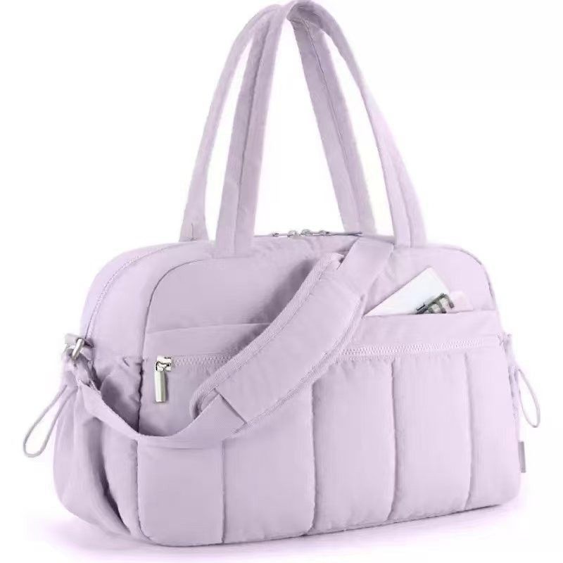Light purple quilted shoulder travel tote bag with front zip pocket and side zipper