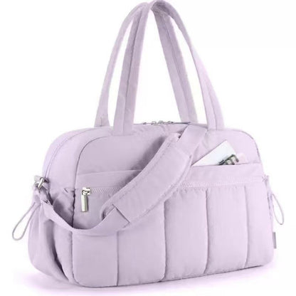 Light purple quilted shoulder travel tote bag with front zip pocket and side zipper