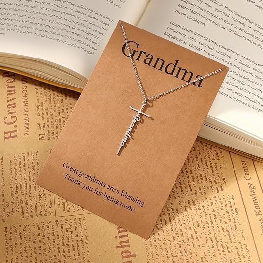 Silver cross pendant necklace with Grandma word charm on a delicate chain.