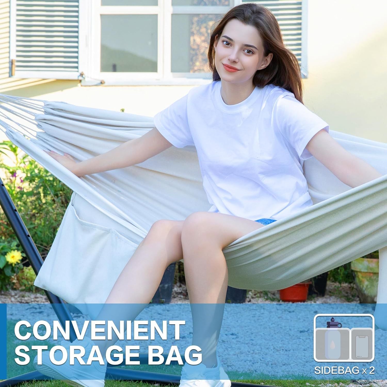Double hammock with white fabric and side storage bag; woman seated on black stand.