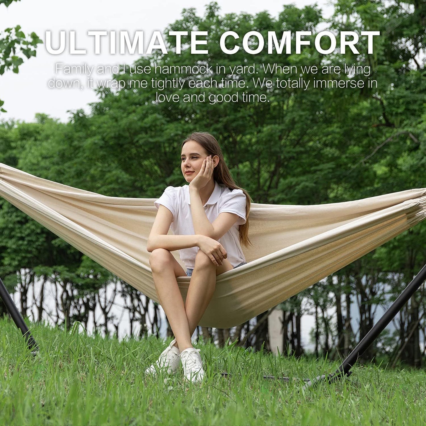Cream double hammock on black stand; woman relaxing outdoors in a yard.