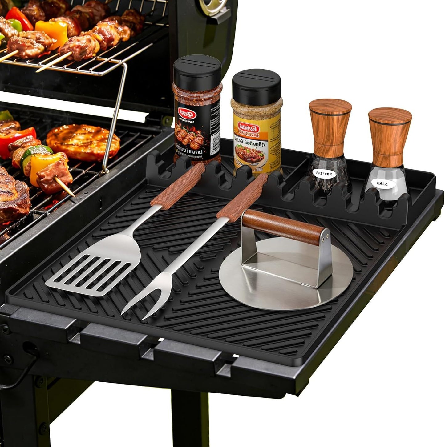 Black silicone tools mat with ribbed tray and molded slots for grilling tools