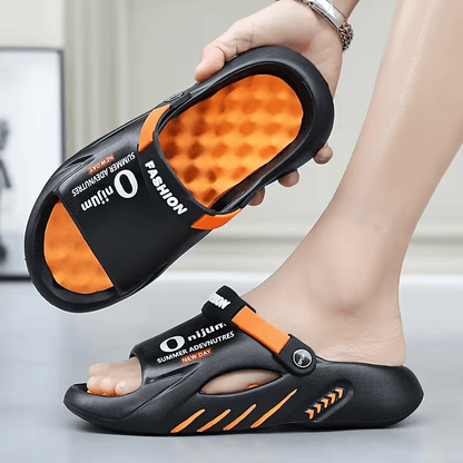 Black EVA clog sandals with orange accents, adjustable strap, and textured footbed