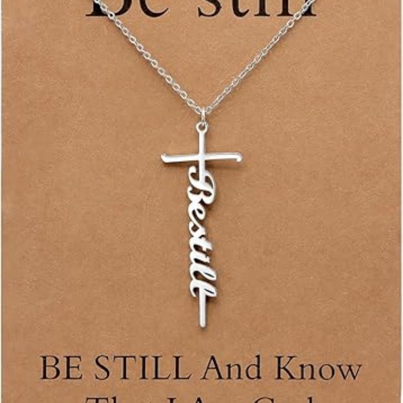 Faith cross pendant necklace with “Be still” script charm on silver chain