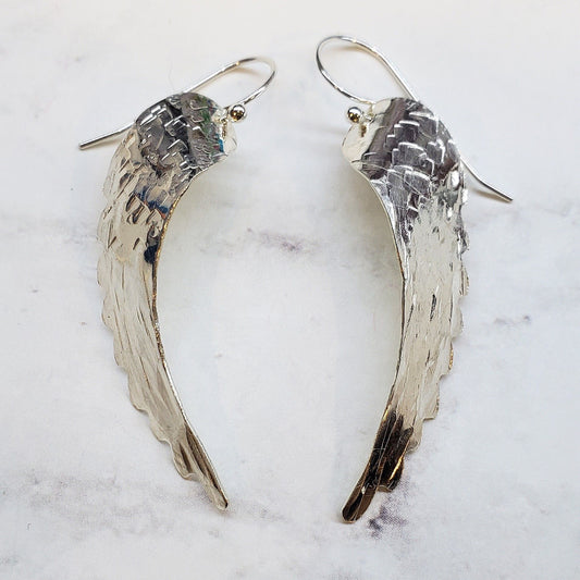 Sterling silver angel wing earrings with hammered texture and sculpted wing shapes