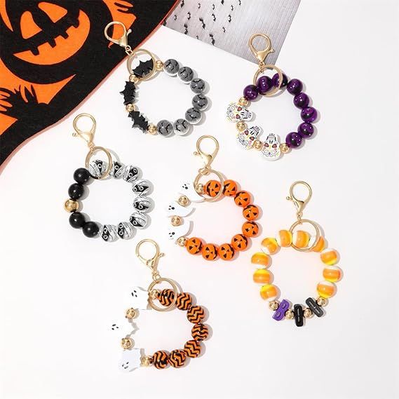 Assorted Halloween beaded keychains display with orange, purple, and black rings