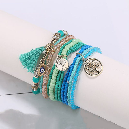 Multilayer beaded bracelet set with turquoise, teal, and blue beads plus gold charms