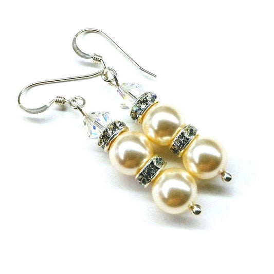 Sterling silver dangle earrings with cream pearls, crystal accents, and hook backs