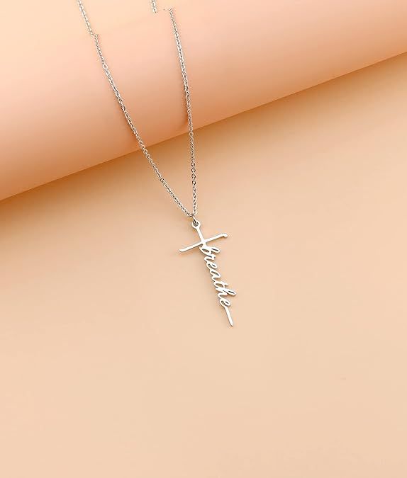 Silver-tone cross with cursive faith pendant on a fine chain necklace